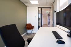 Bureau met curved monitor en luxe fauteuil in de Gerrit Karsten-kamer