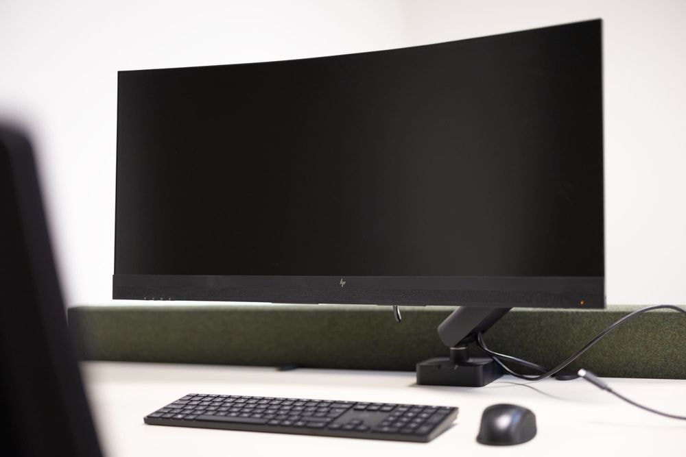Gijs Versteeg kamer met 34-inch curved monitor, toetsenbord en muis — Mudde Kok FlexCentre
